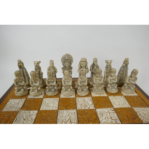 133 - A composition chess set in the form of Myan deities, complete, 40 x 40cm