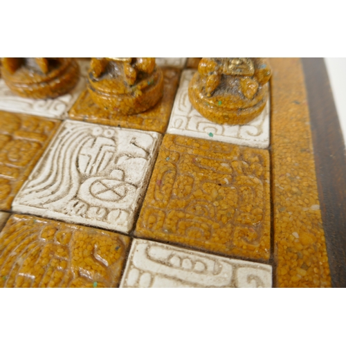 133 - A composition chess set in the form of Myan deities, complete, 40 x 40cm