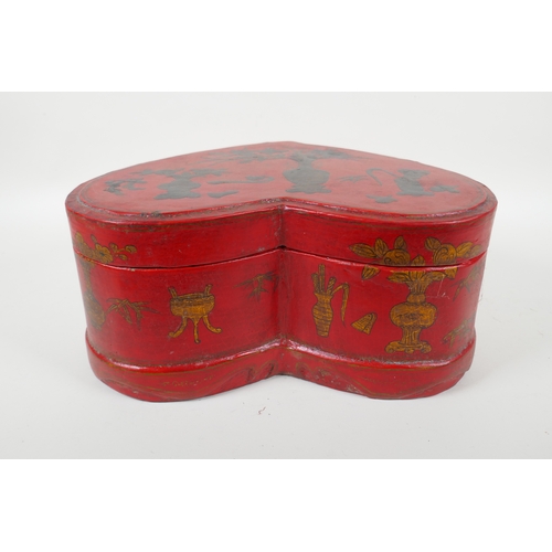 135 - A Chinese red lacquered heart shaped box decorated with objects of virtue in gilt, 32 x 26cm