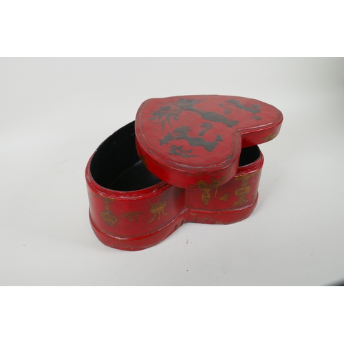 135 - A Chinese red lacquered heart shaped box decorated with objects of virtue in gilt, 32 x 26cm