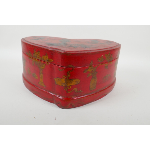 135 - A Chinese red lacquered heart shaped box decorated with objects of virtue in gilt, 32 x 26cm