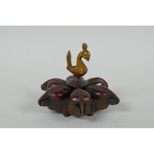 136 - An Indian bronze six section tikka pot, a filled bronze Buddha's hand, and a Tibetan bronze vajra, l... 