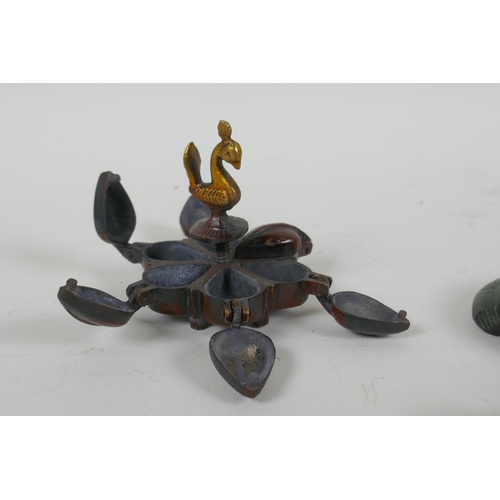 136 - An Indian bronze six section tikka pot, a filled bronze Buddha's hand, and a Tibetan bronze vajra, l... 