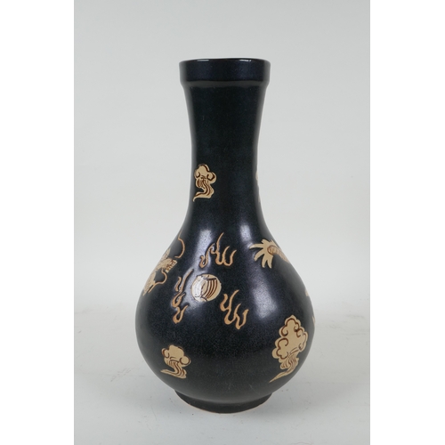 138 - A Chinese Cizhou kiln bottle vase with dragon decoration, 29cm high