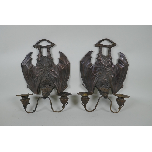 140 - A pair of gothic style bronze two branch wall sconces in the form of bats, 24 x 33cm