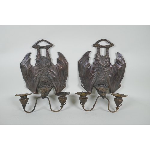 140 - A pair of gothic style bronze two branch wall sconces in the form of bats, 24 x 33cm