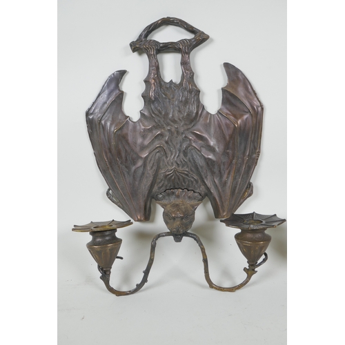 140 - A pair of gothic style bronze two branch wall sconces in the form of bats, 24 x 33cm