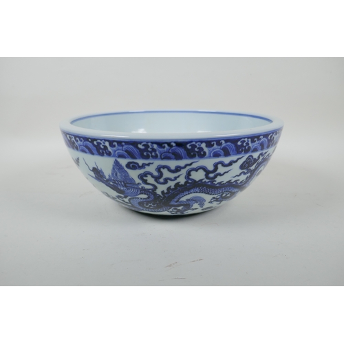 147 - A blue and white porcelain bowl decorated with two dragons, Chinese Xuande 6 character mark to bowl,... 