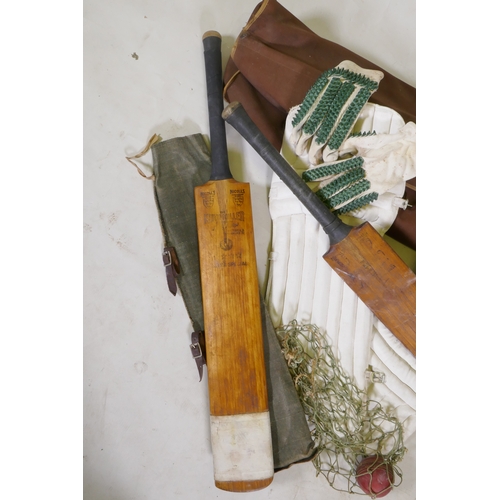 15 - A collection of vintage cricket equipment to include two Keith Miller autograph bats, a set of pads,... 