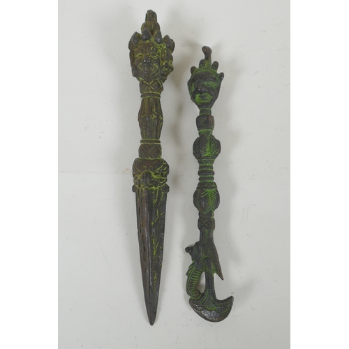 150 - A Tibetan cast iron phurba with a wrathful deity mask handle, and a similar cast iron kartika, 22cm ... 