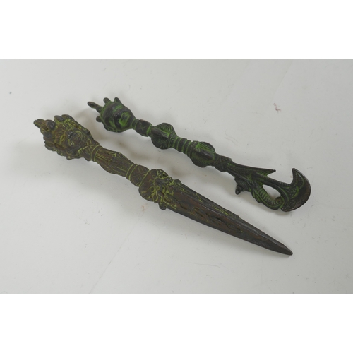 150 - A Tibetan cast iron phurba with a wrathful deity mask handle, and a similar cast iron kartika, 22cm ... 