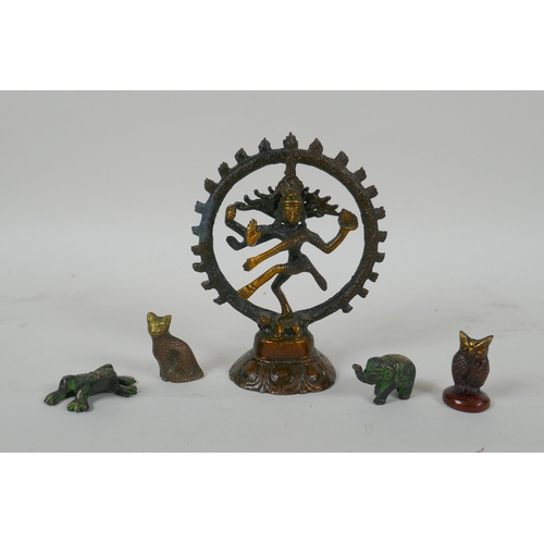 151 - A Tibetan bronzed metal figure of Nataraja, and four smaller incense  stick holders in the for ... 