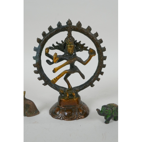 151 - A Tibetan bronzed metal figure of Nataraja, and four smaller incense  stick holders in the for ... 