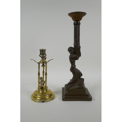 159 - An antique brass candle stick with putto decoration, together with an Art Nouveau style bronzed cast... 