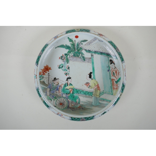 165 - A famille vert porcelain dish with a rolled rim, decorated with figures in a garden, Chinese KangXi ... 