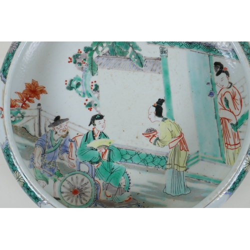 165 - A famille vert porcelain dish with a rolled rim, decorated with figures in a garden, Chinese KangXi ... 