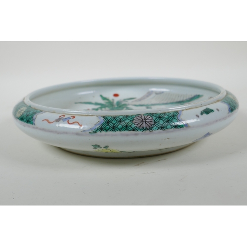 165 - A famille vert porcelain dish with a rolled rim, decorated with figures in a garden, Chinese KangXi ... 