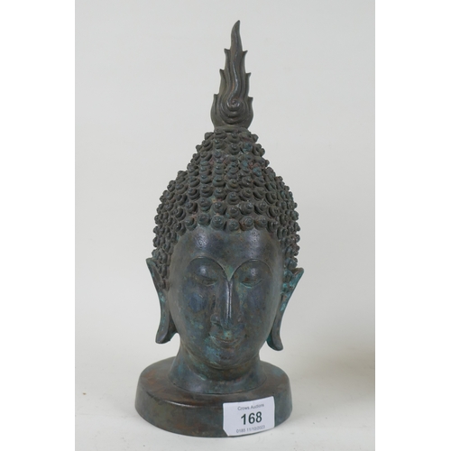 168 - A vintage bronze Buddha's head, mounted on a metal stand, 27cm high