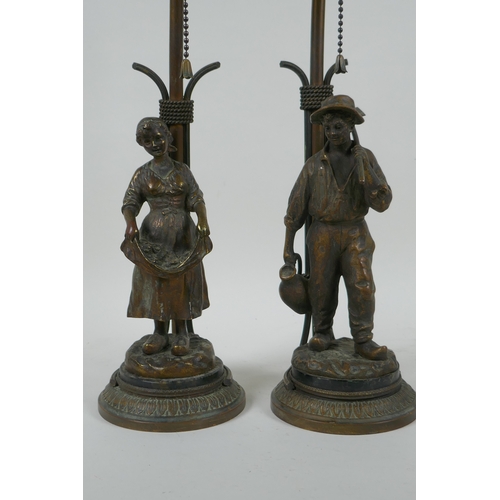 17 - A pair of Dutch gilt bronze figural table lamps of farm workers, after Joseph D'Aste, (1881-1945), 4... 