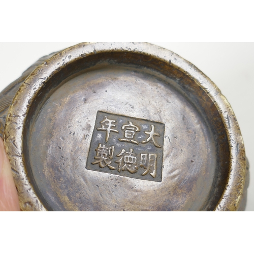 178 - A Chinese bronze censer with dragon mask handles and raised dragon decoration, Xuande 6 character ma... 