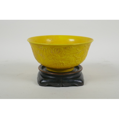 181 - A yellow ground porcelain rice bowl with raised triple dragon decoration, Chinese YongZheng 6 charac... 