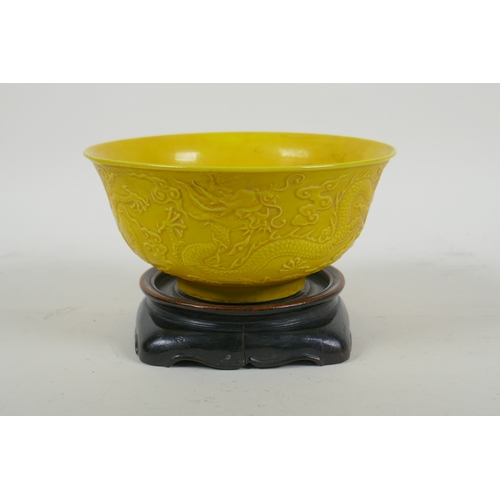 181 - A yellow ground porcelain rice bowl with raised triple dragon decoration, Chinese YongZheng 6 charac... 