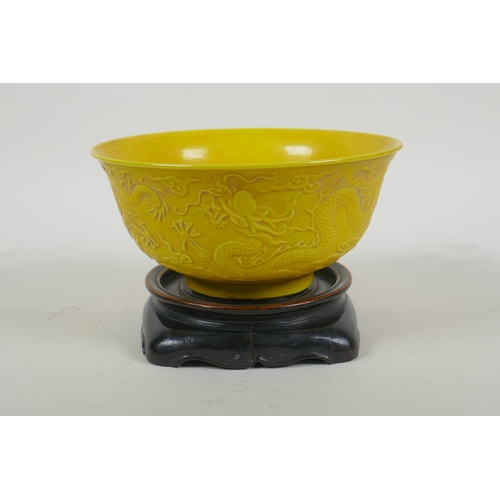 181 - A yellow ground porcelain rice bowl with raised triple dragon decoration, Chinese YongZheng 6 charac... 