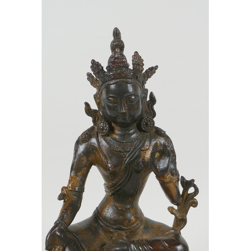 190 - A Sino Tibetan gilt bronzed metal figure of Buddha, 4 character mark to the reverse, 27cm high