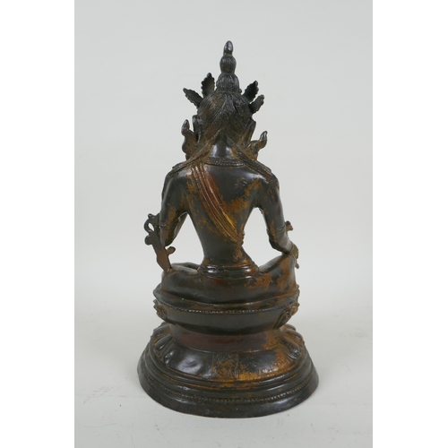 190 - A Sino Tibetan gilt bronzed metal figure of Buddha, 4 character mark to the reverse, 27cm high