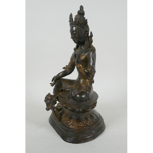 190 - A Sino Tibetan gilt bronzed metal figure of Buddha, 4 character mark to the reverse, 27cm high