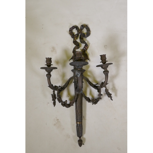 191 - An Empire style three branch wall sconce in the form of an arrow quiver, with ribbons and floral swa... 