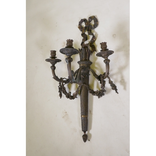 191 - An Empire style three branch wall sconce in the form of an arrow quiver, with ribbons and floral swa... 