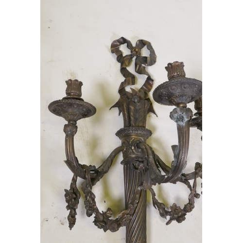 191 - An Empire style three branch wall sconce in the form of an arrow quiver, with ribbons and floral swa... 