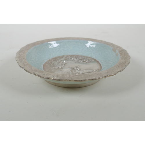 193 - A Chinese celadon ground porcelain dish with lobed rim, and silver glazed details, decorated with a ... 