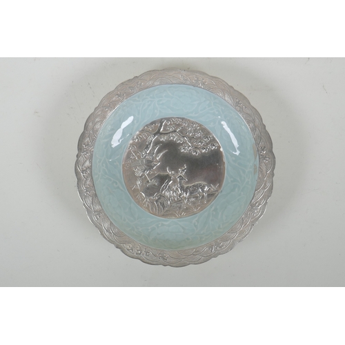 193 - A Chinese celadon ground porcelain dish with lobed rim, and silver glazed details, decorated with a ... 