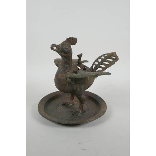 195 - A Chinese archaic style bronzed metal censer in the form of a phoenix standing on a platter, 20cm hi... 