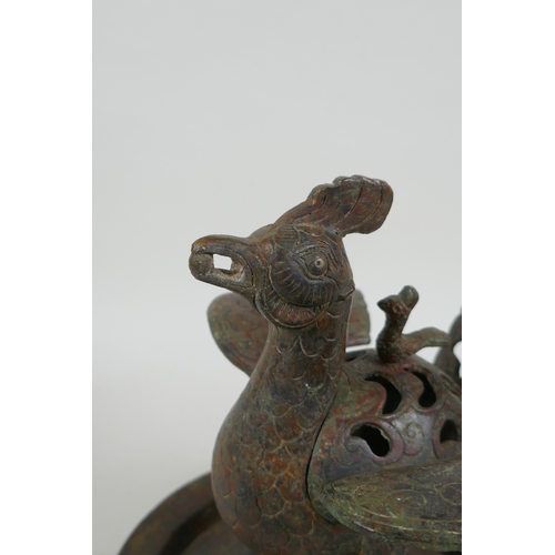 195 - A Chinese archaic style bronzed metal censer in the form of a phoenix standing on a platter, 20cm hi... 