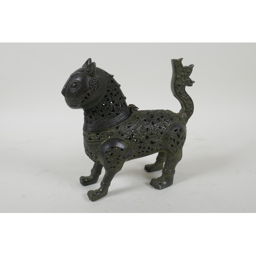 199 - A Persian pierced bronze lion censer and cover, 18cm high