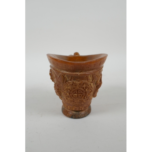 200 - A Chinese faux horn libation cup with carved kylin decoration, seal mark to base, 10cm high