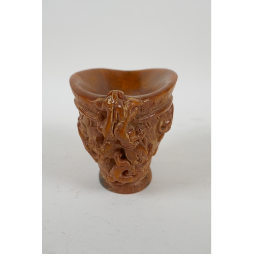 200 - A Chinese faux horn libation cup with carved kylin decoration, seal mark to base, 10cm high