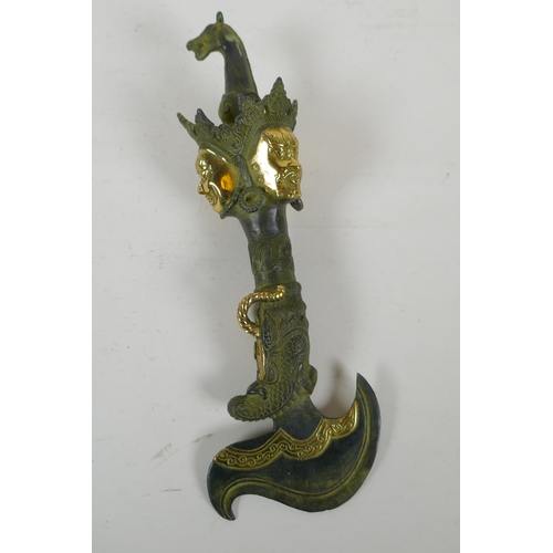 201 - A Tibetan filled bronze kartika with gilt highlights, 28cm long