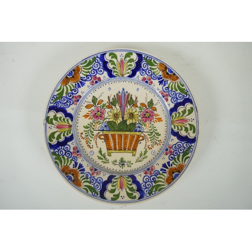 202 - A polychrome Delft cabinet dish with floral decoration, mark to bae, AF, 25cm diameter