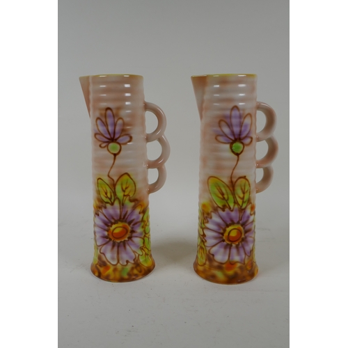 205 - A pair of Royal Art Pottery jugs with floral decoration, 24cm high