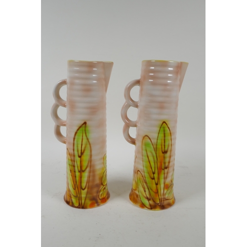 205 - A pair of Royal Art Pottery jugs with floral decoration, 24cm high