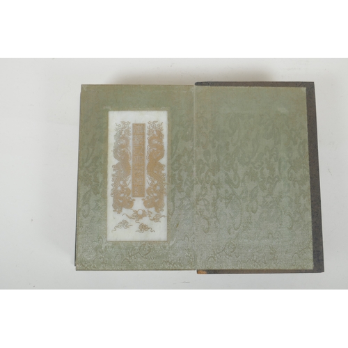 214 - A Chinese wood and silk bound book containing white jade table pages with chased and gilt inscriptio... 