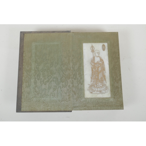 214 - A Chinese wood and silk bound book containing white jade table pages with chased and gilt inscriptio... 