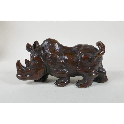 224 - A filled bronze rhinoceros, 19cm long