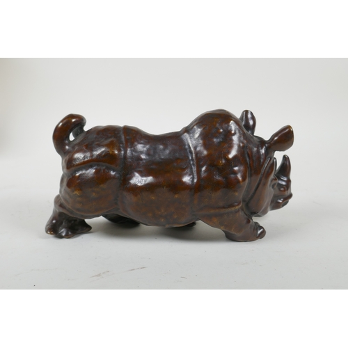 224 - A filled bronze rhinoceros, 19cm long