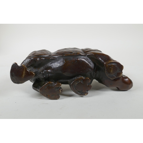 224 - A filled bronze rhinoceros, 19cm long