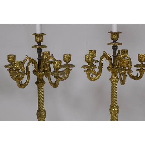 226 - A pair of ormolu five branch candelabra table lamps with twisted columns and scroll supports, 84cm h... 